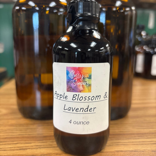 Bottle of Apple Blossom & Lavender fragrance on a wooden surface