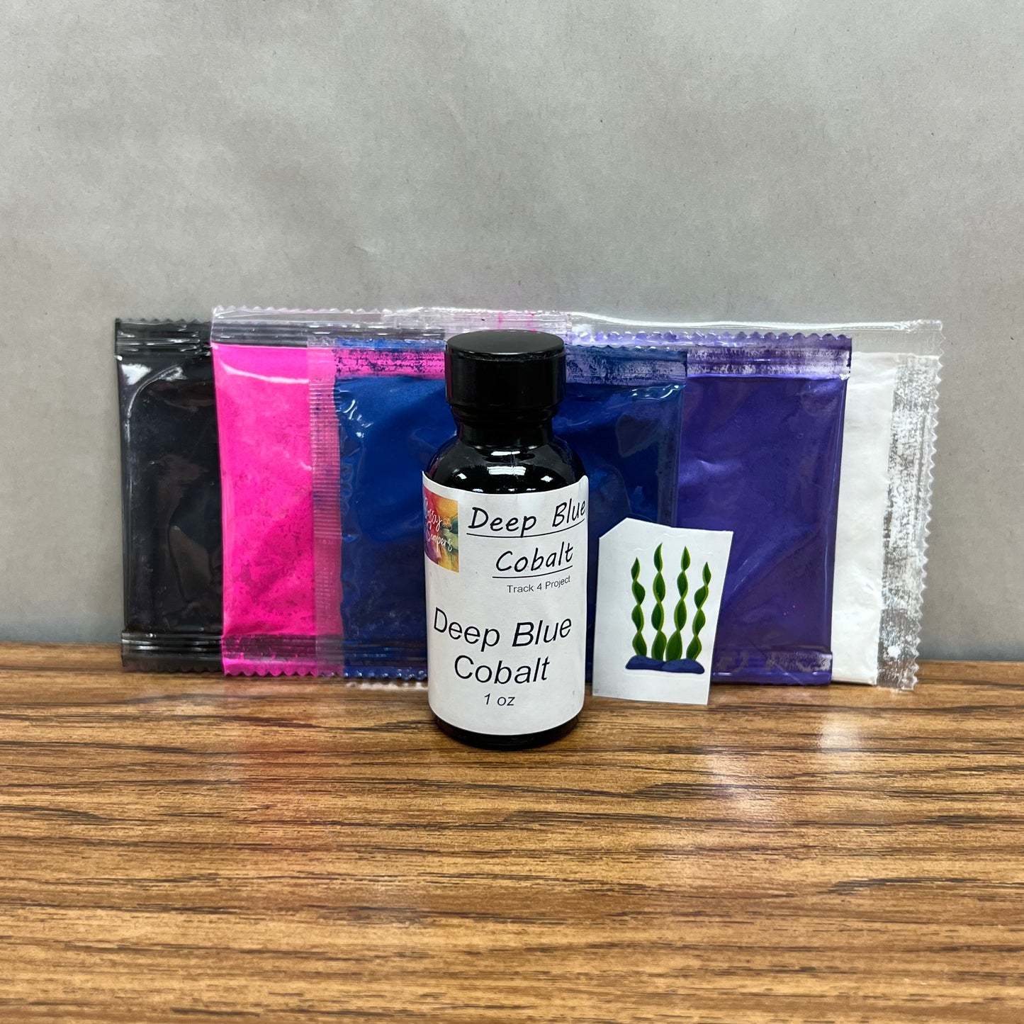 1 ounce bottle of Deep Blue Cobalt fragrance oil and colorant packets of white, purple, dark blue, pink and black.