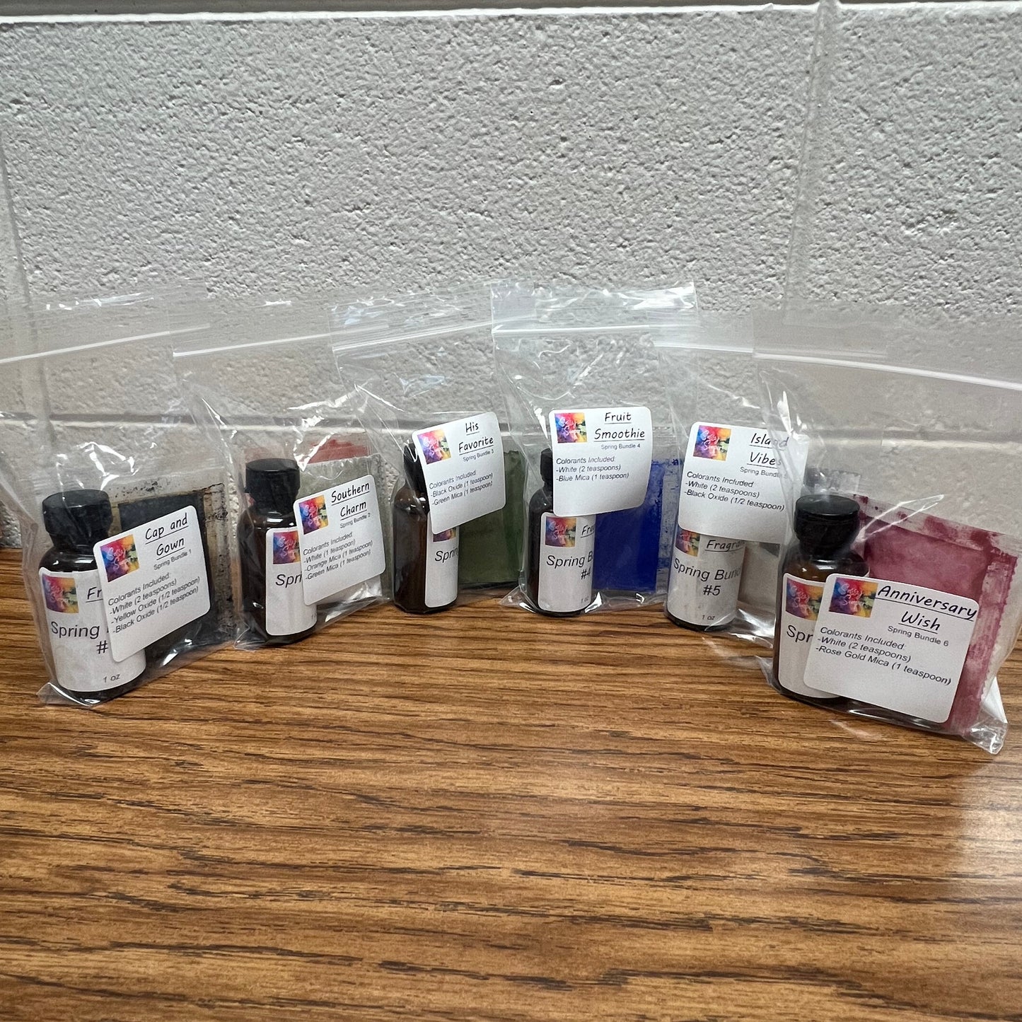 Row of ink cartridges on a wooden surface with a white wall background