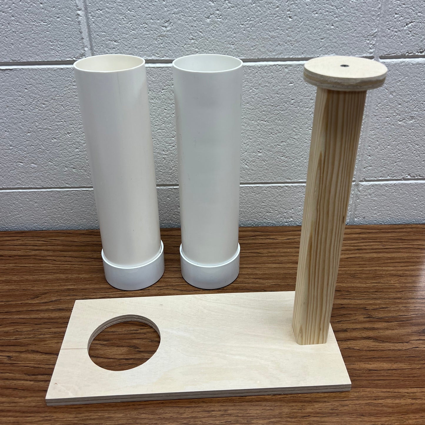 Pair of 3" PVC pipe molds with wooden pushing device for unmolding soap.