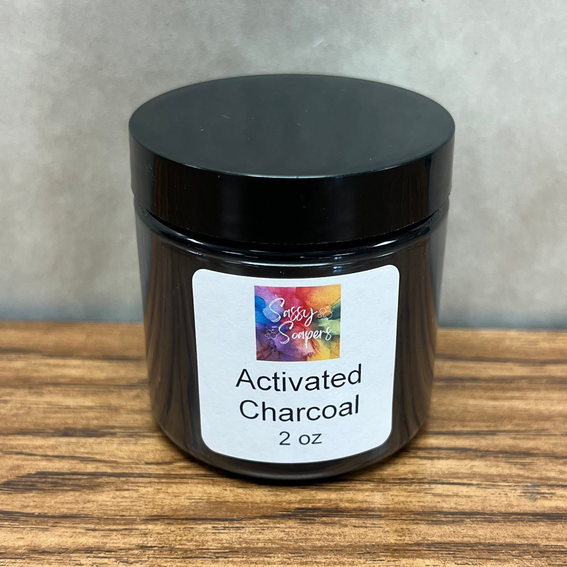 2 ounce clear plastic container of activated charcoal.