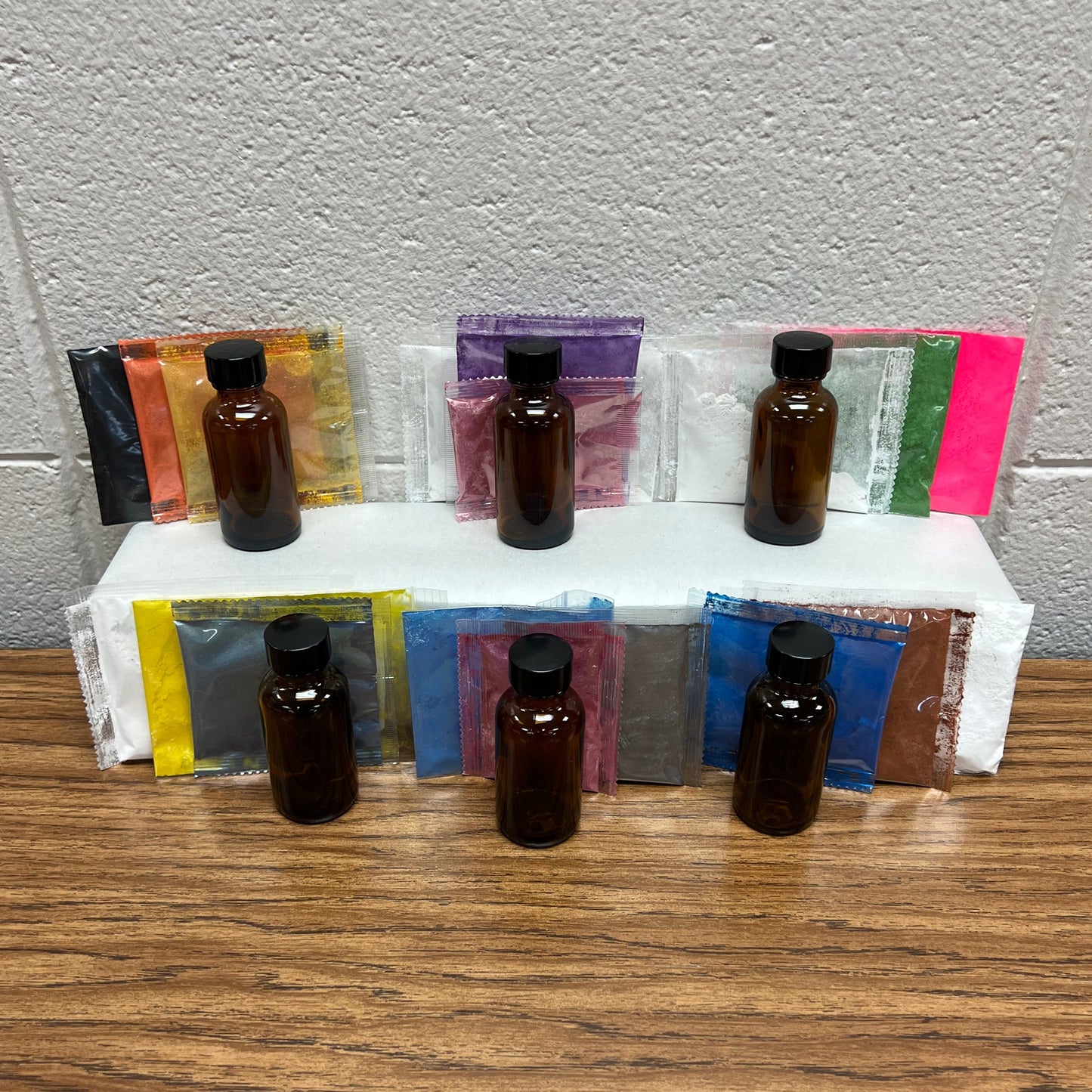 Display of 6 scent and colorant kits with multiple colors.