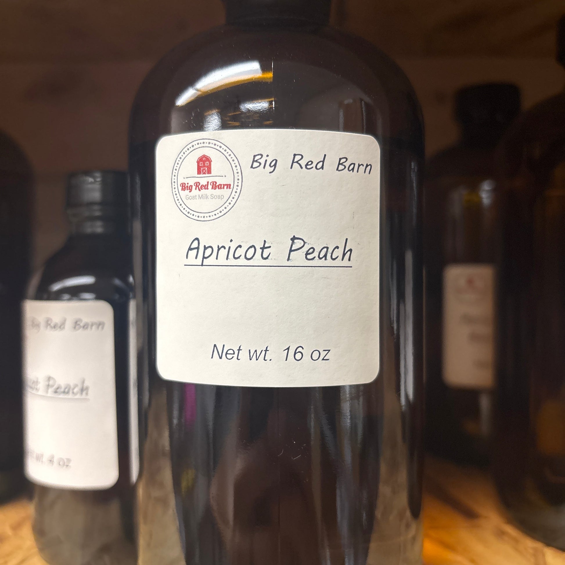 Bottle of Big Red Barn Apricot Peach  fragrence oils on a wooden surface