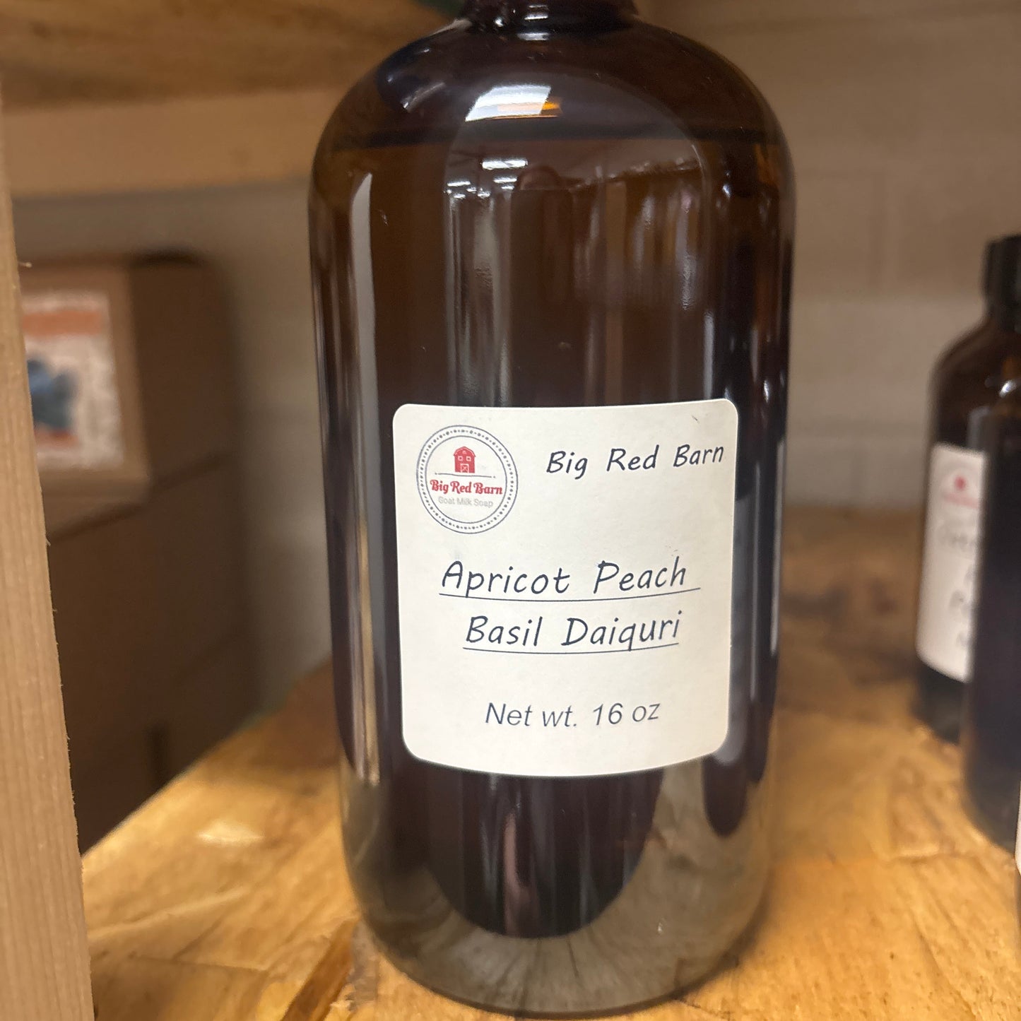Apricot Peach Basil Daiquri fragrence oils bottle with a label on a wooden surface
