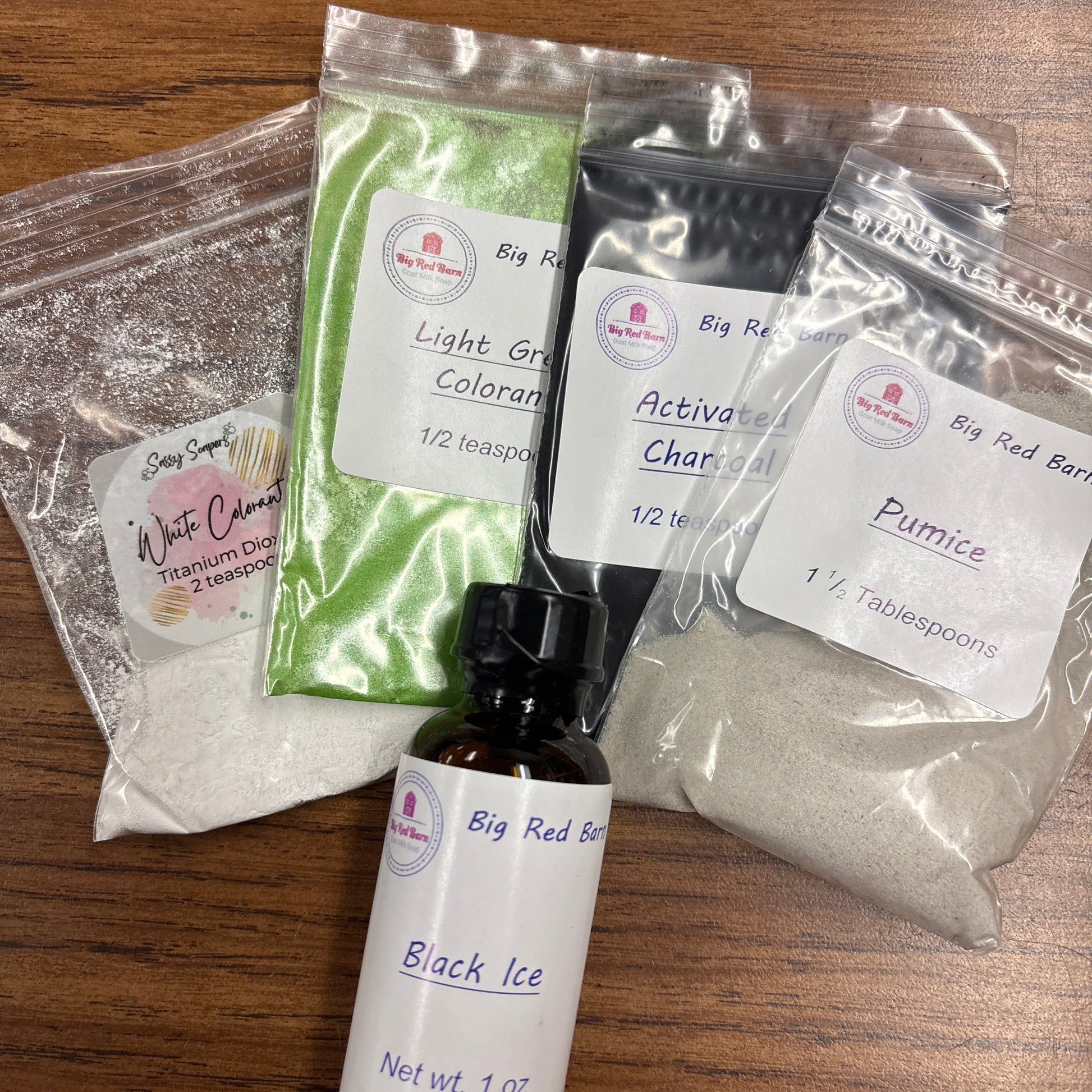Colorants and a bottle of fragrance on a wooden table