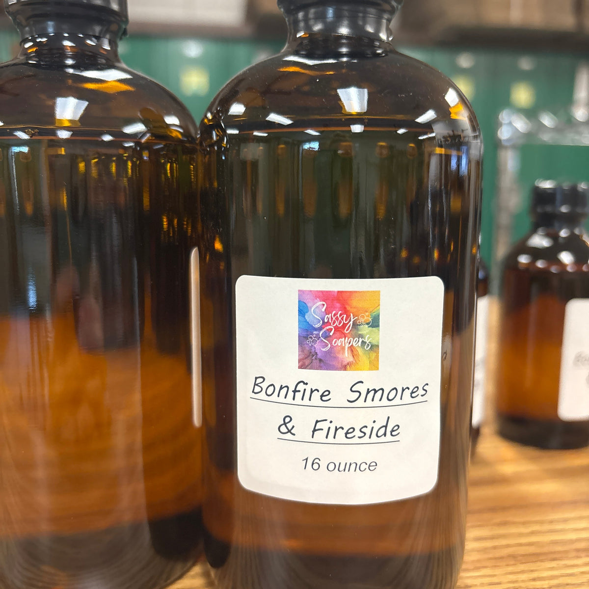 Bottle of 'Bonfire, Smores & Fireside' fragrence oils on a wooden surface