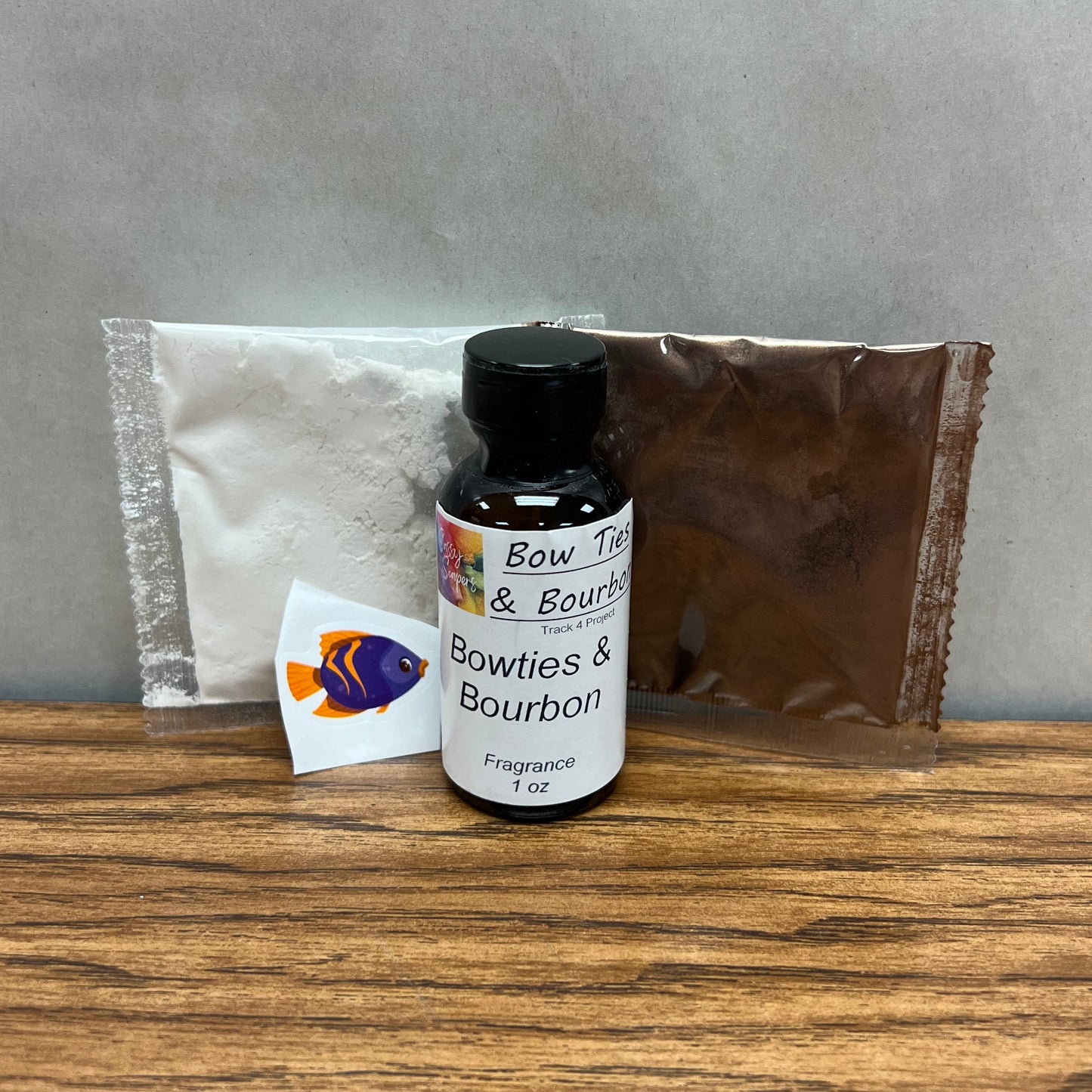 Brown bottle of Bowties and Bourbon fragrance oil with white and brown colorant packets.