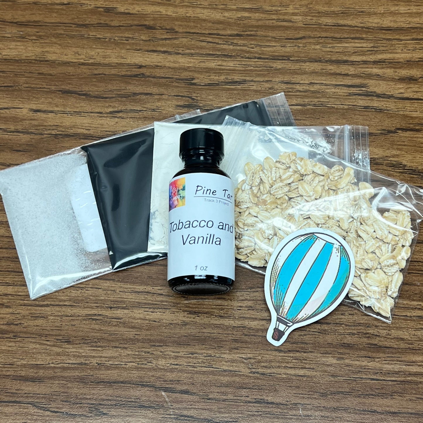 Pine Tar Soap Making Kit including 1 ounce of fragrance oil and 3 colorants and rolled oats.