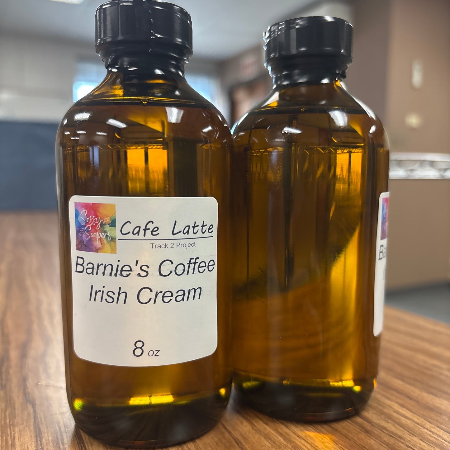 Two bottles of Barnie's Coffee Irish Cream fragrence oil on a wooden surface