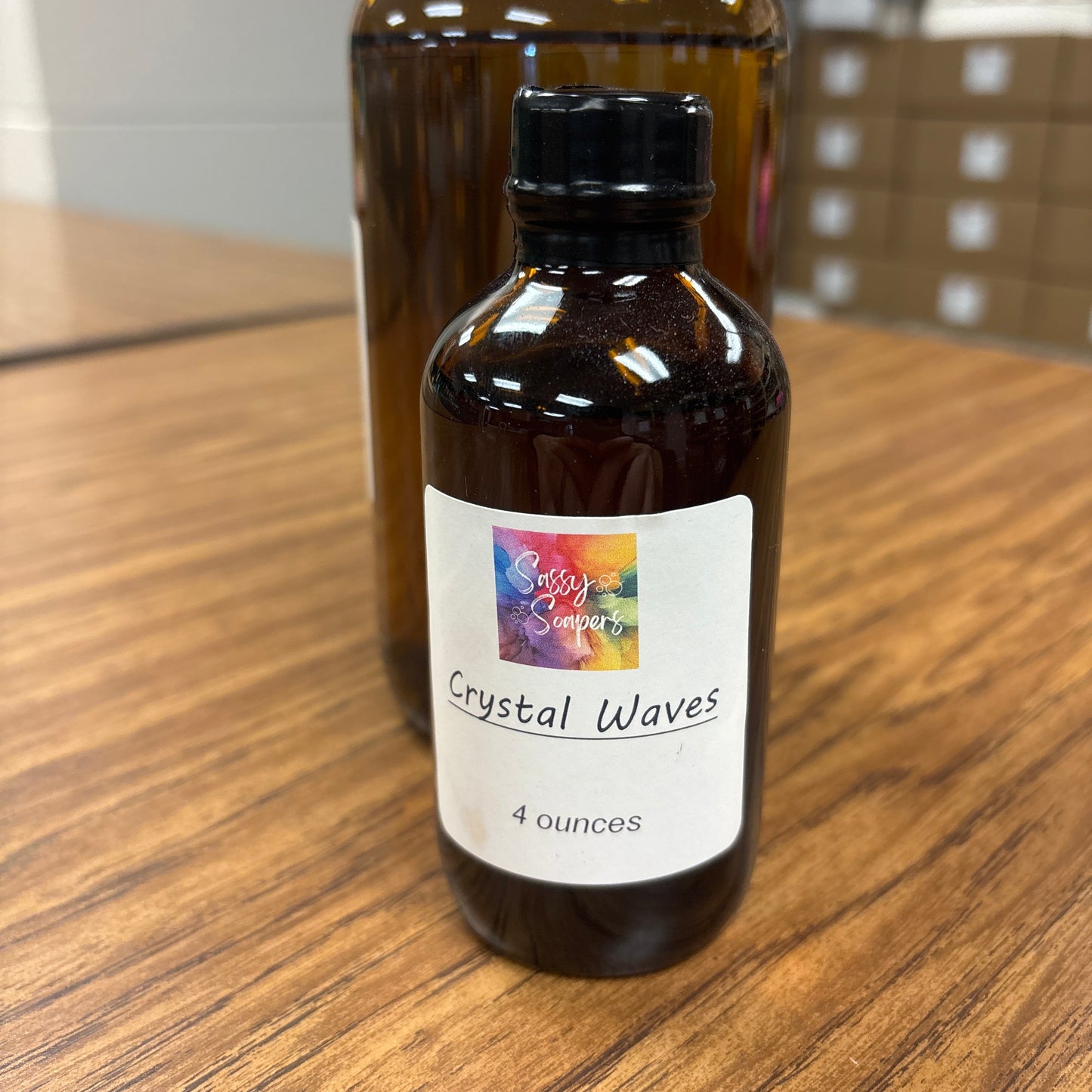 Bottle of 'Crystal Waves' fragrence oils on a wooden surface