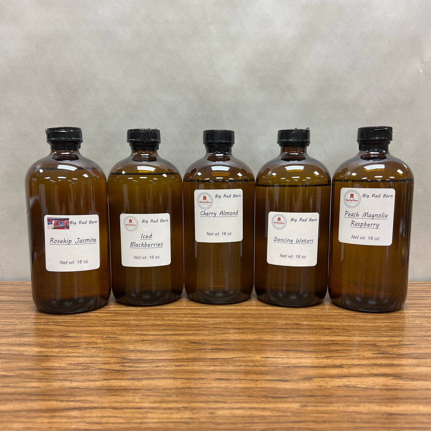Five, 6 ounce brown bottles of fragrance oils - Rosehip Jasmine, Iced Berries, Cherry Almond, Dancing Waters and Peach Magnolia Raspberry.