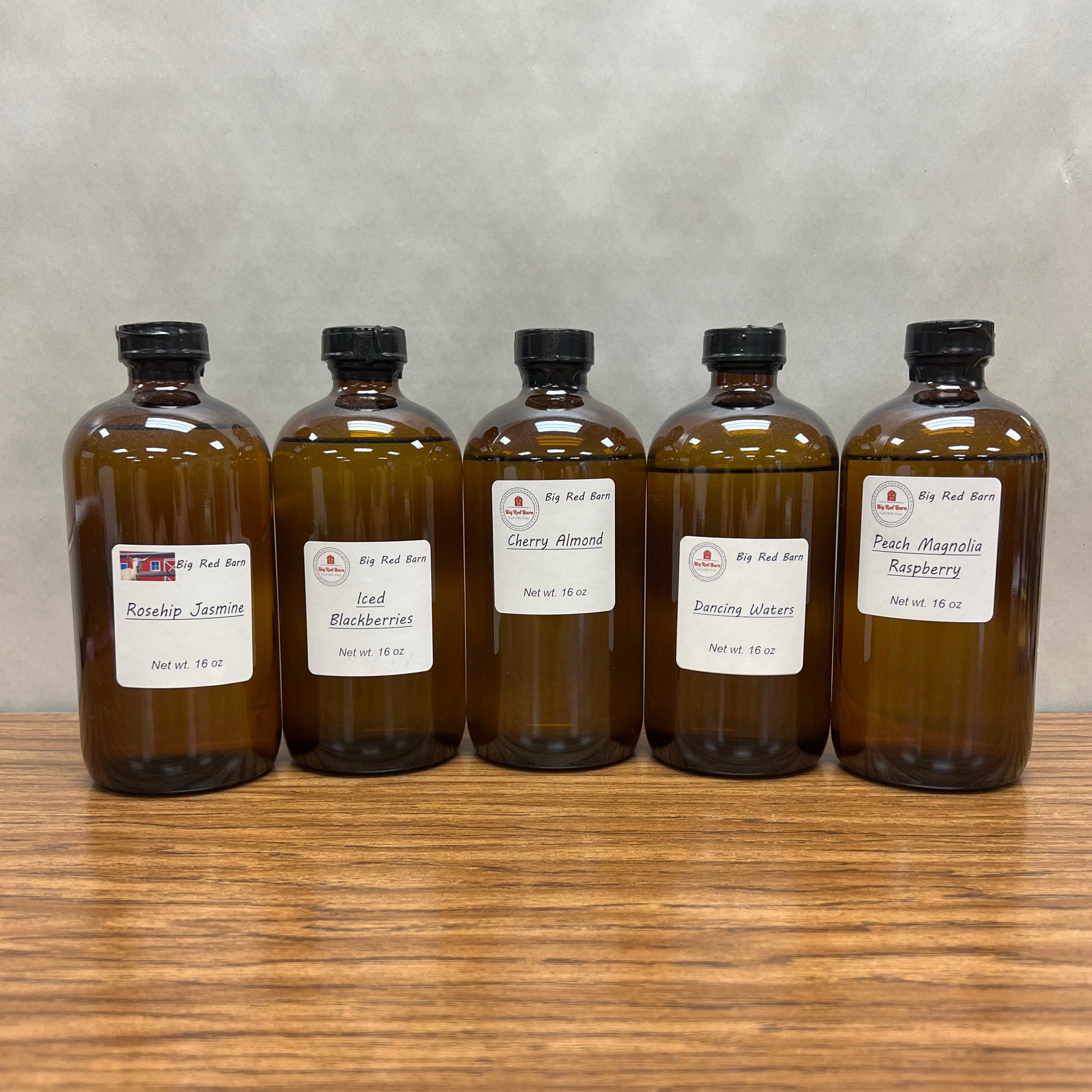 Five, 6 ounce brown bottles of fragrance oils - Rosehip Jasmine, Iced Berries, Cherry Almond, Dancing Waters and Peach Magnolia Raspberry.