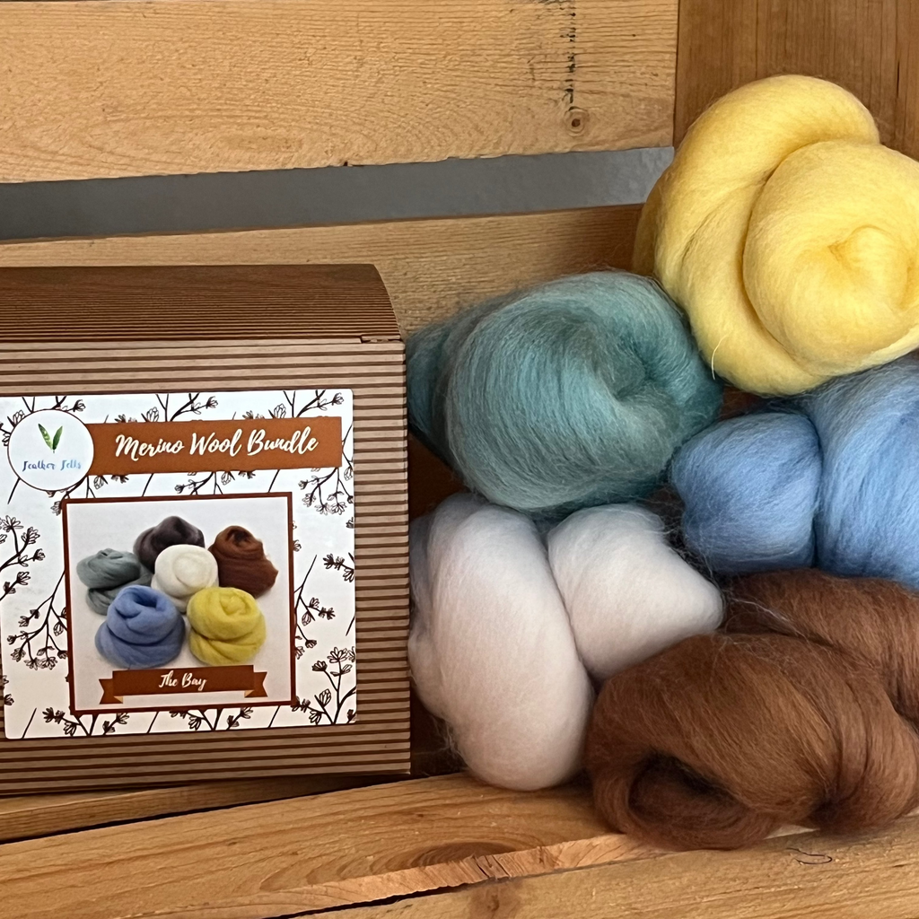 Wool woven for felting soap with six different colors on a wooden surface