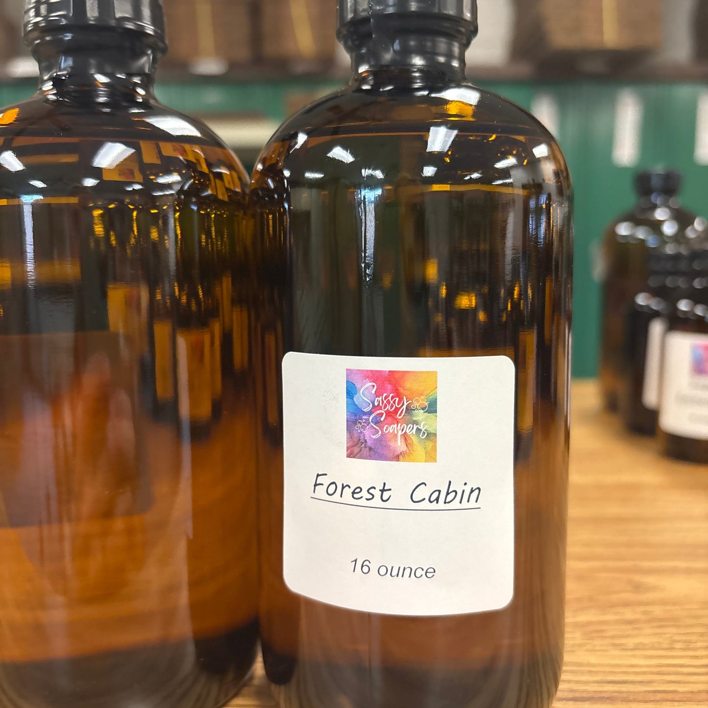 Forest Cabin fragrence oil Bottle with a label on a wooden surface