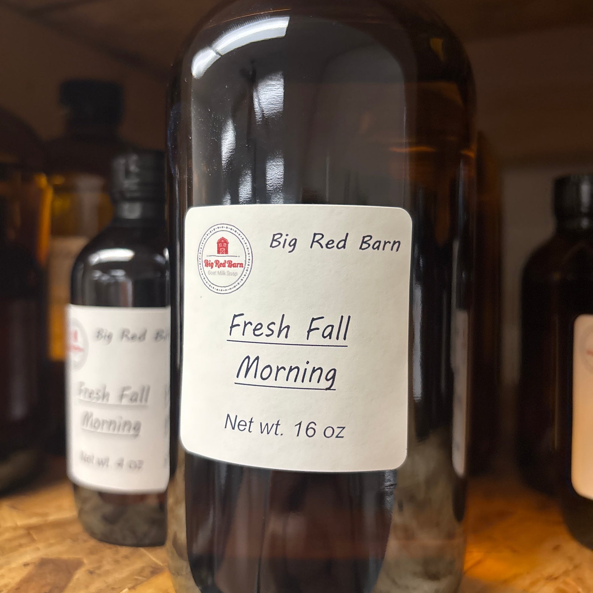 Bottle of Big Red Barn Fresh Fall Morning fragrance with a label on a wooden surface