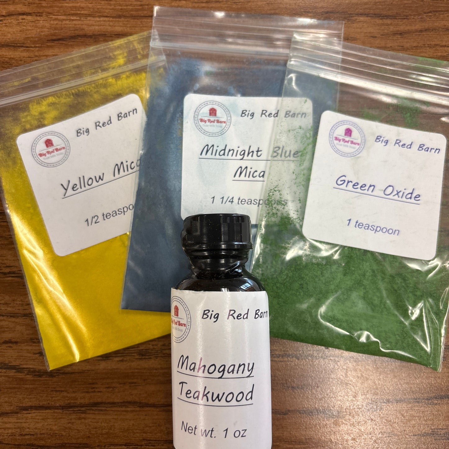 Collection of fragrance bottle and colorants with labels on a wooden surface