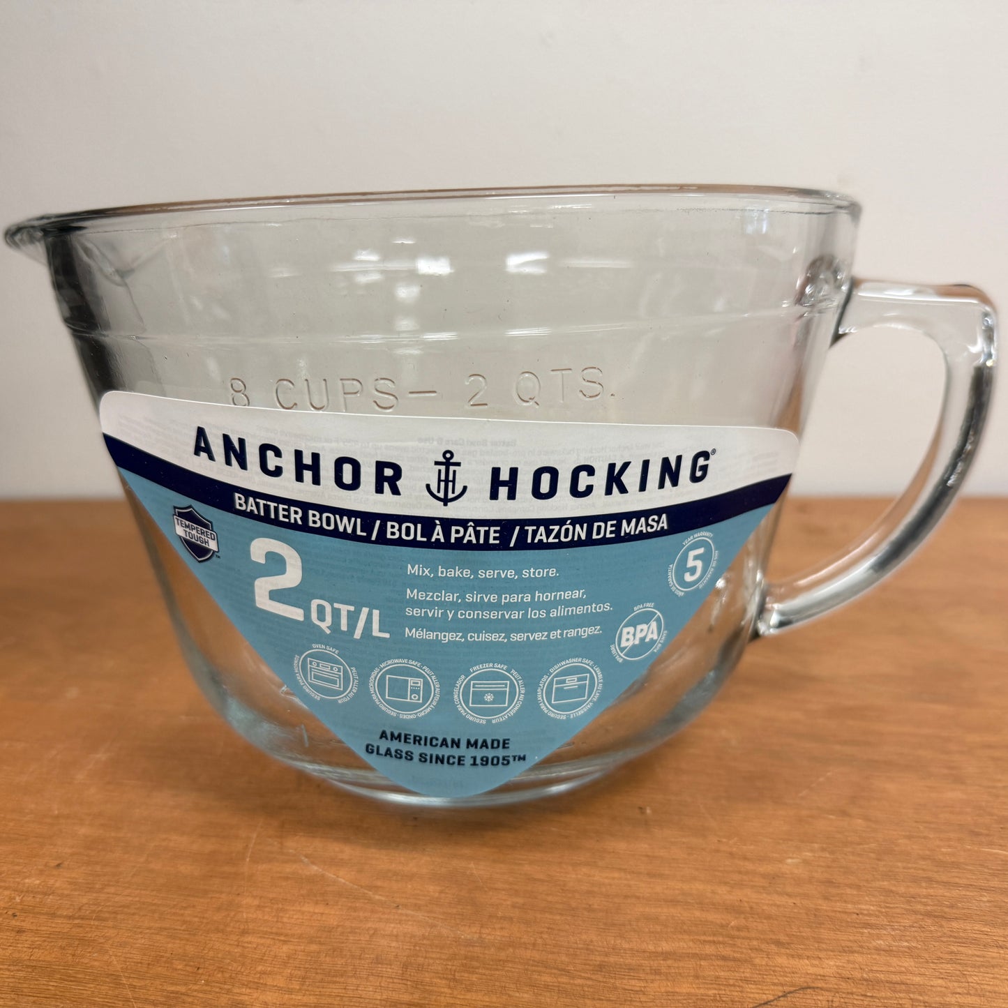 Anchor Hocking glass bowl on a wooden surface with a white background
