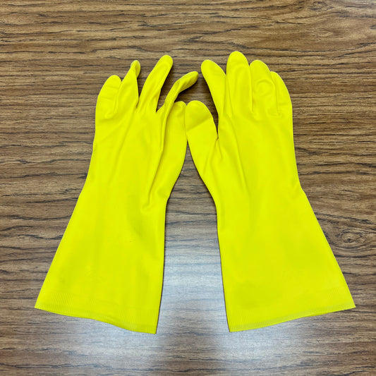 Pair of yellow, medium size chemical resistant gloves for soap making on woodgrain background.