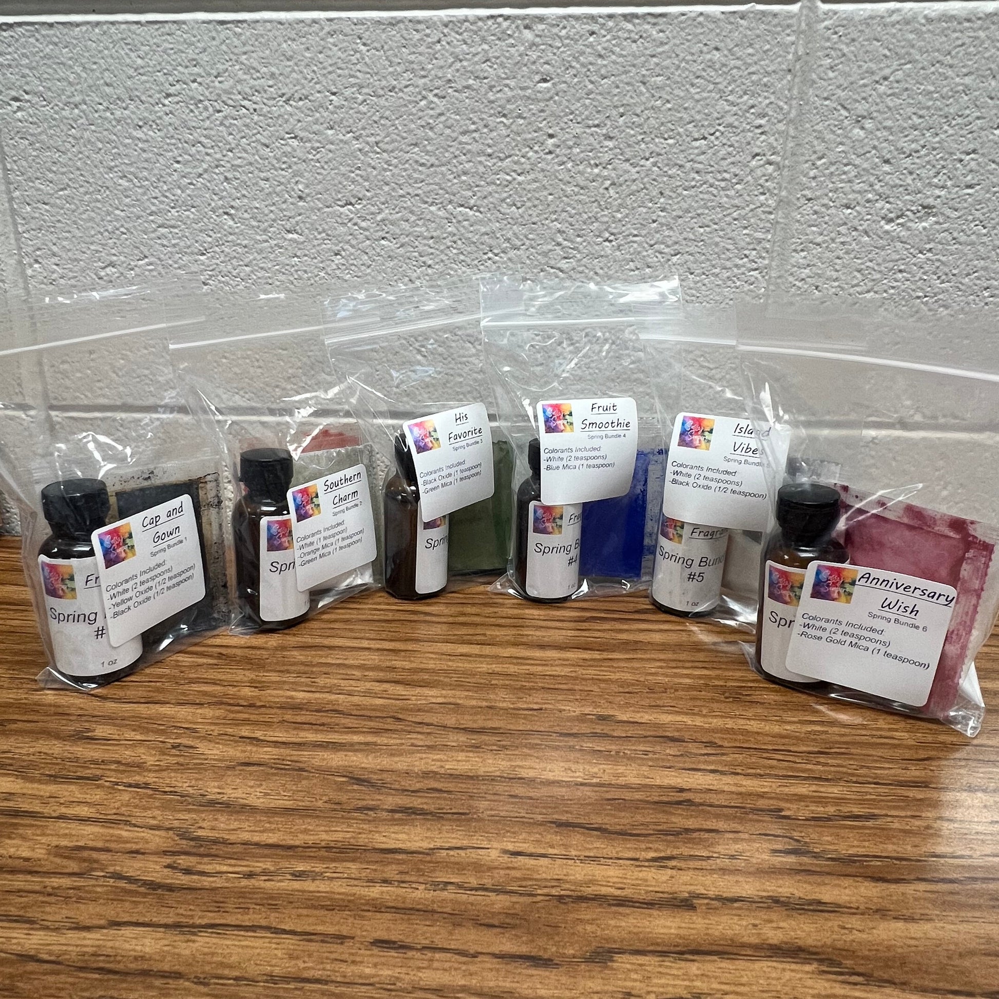 Row of ink cartridges on a wooden surface with a white wall background