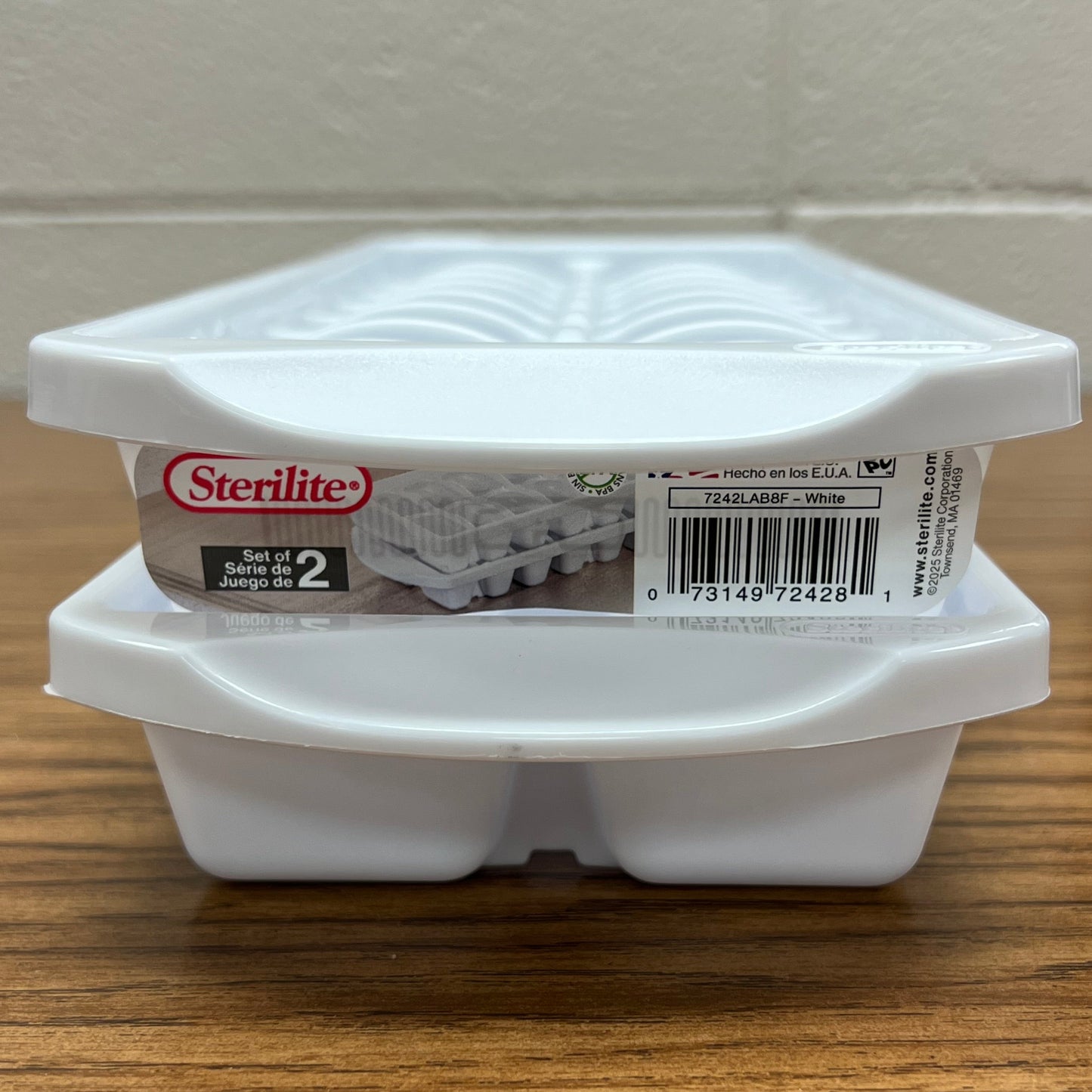 End view of a pair of Sterilte brand white ice cube trays.