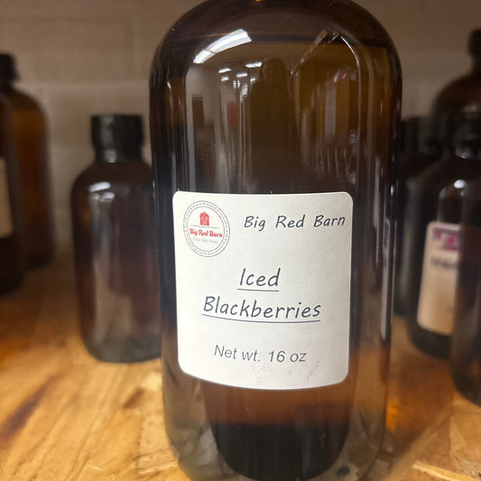 Bottle of Big Red Barn iced blackberries fragrence oils on a wooden surface
