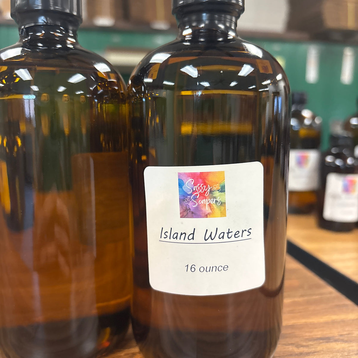 Bottle of Island Waters fragrence oils on a wooden surface with blurred background