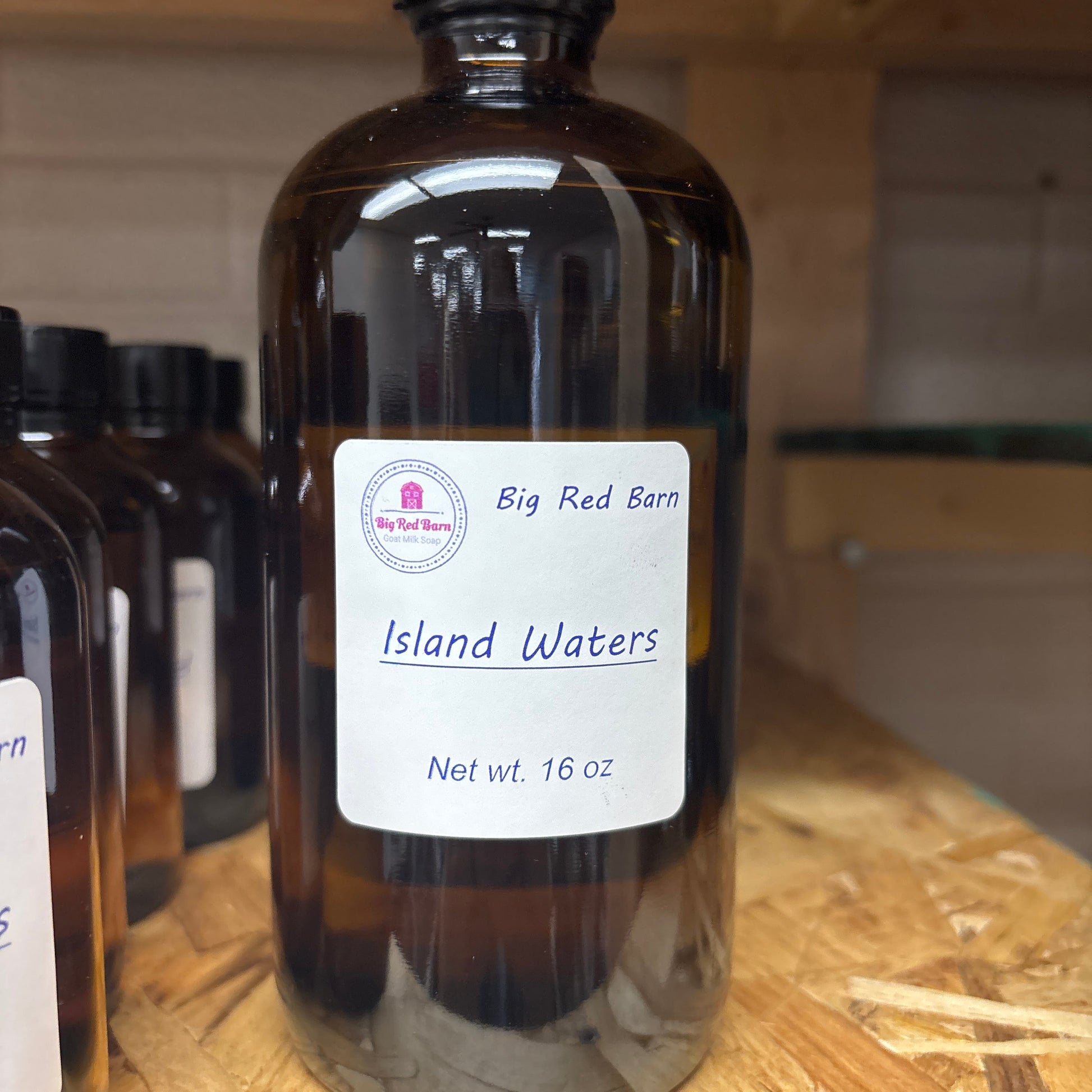 Bottle of Island Waters fragrance on a wooden surface