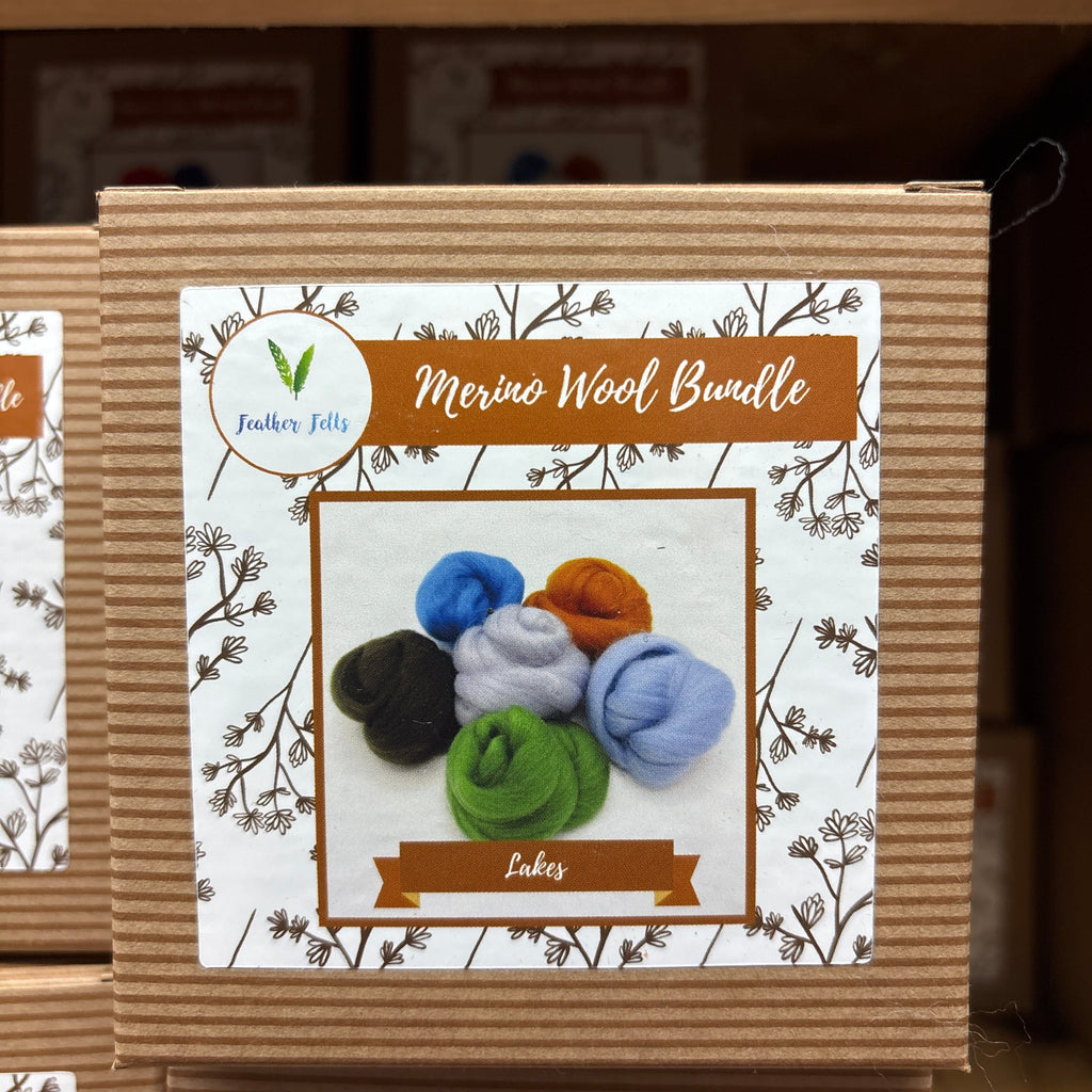 Box of Merino Wool Bundles with colorful wool balls on a decorative label.