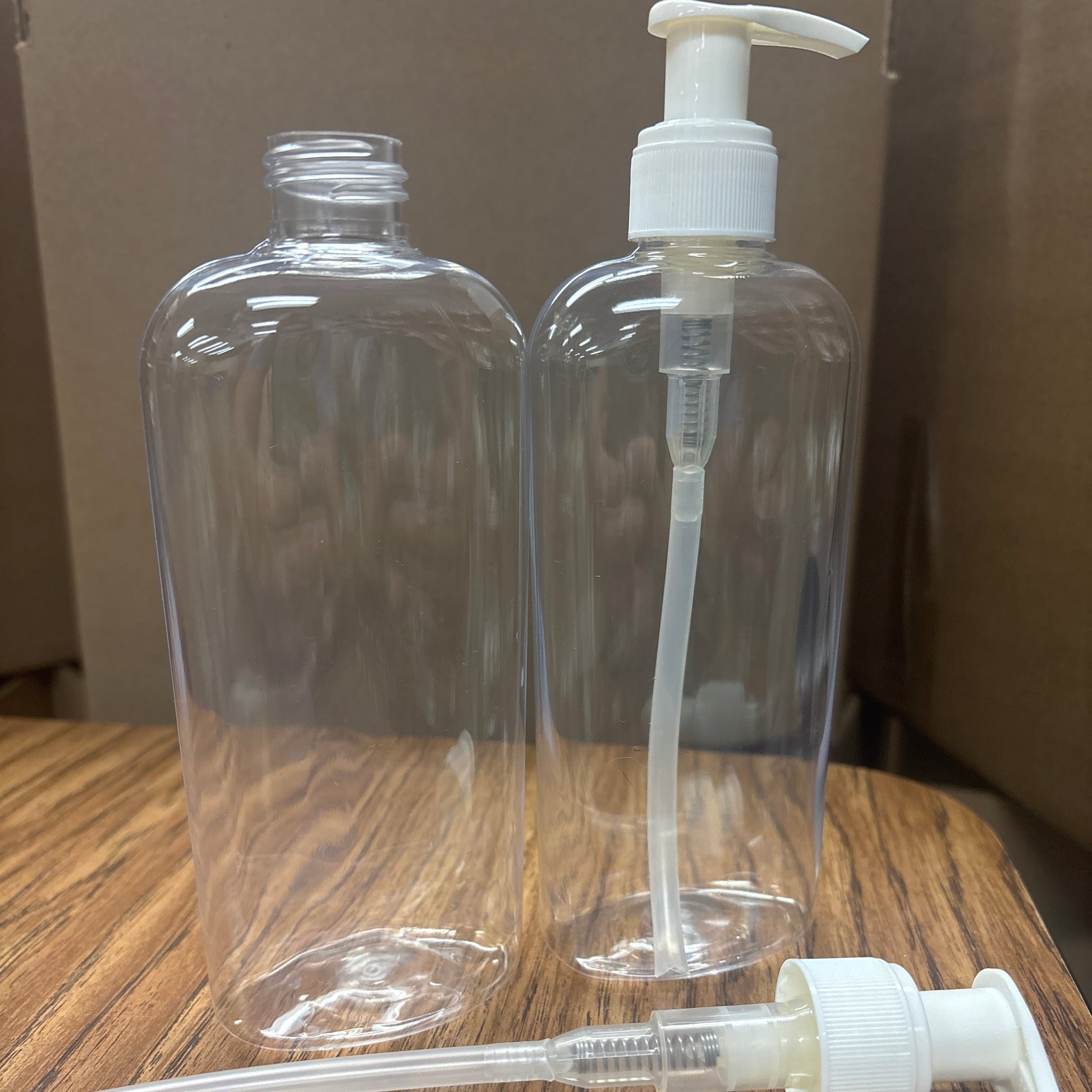 Clear plastic bottles with white pump dispensers on a wooden surface