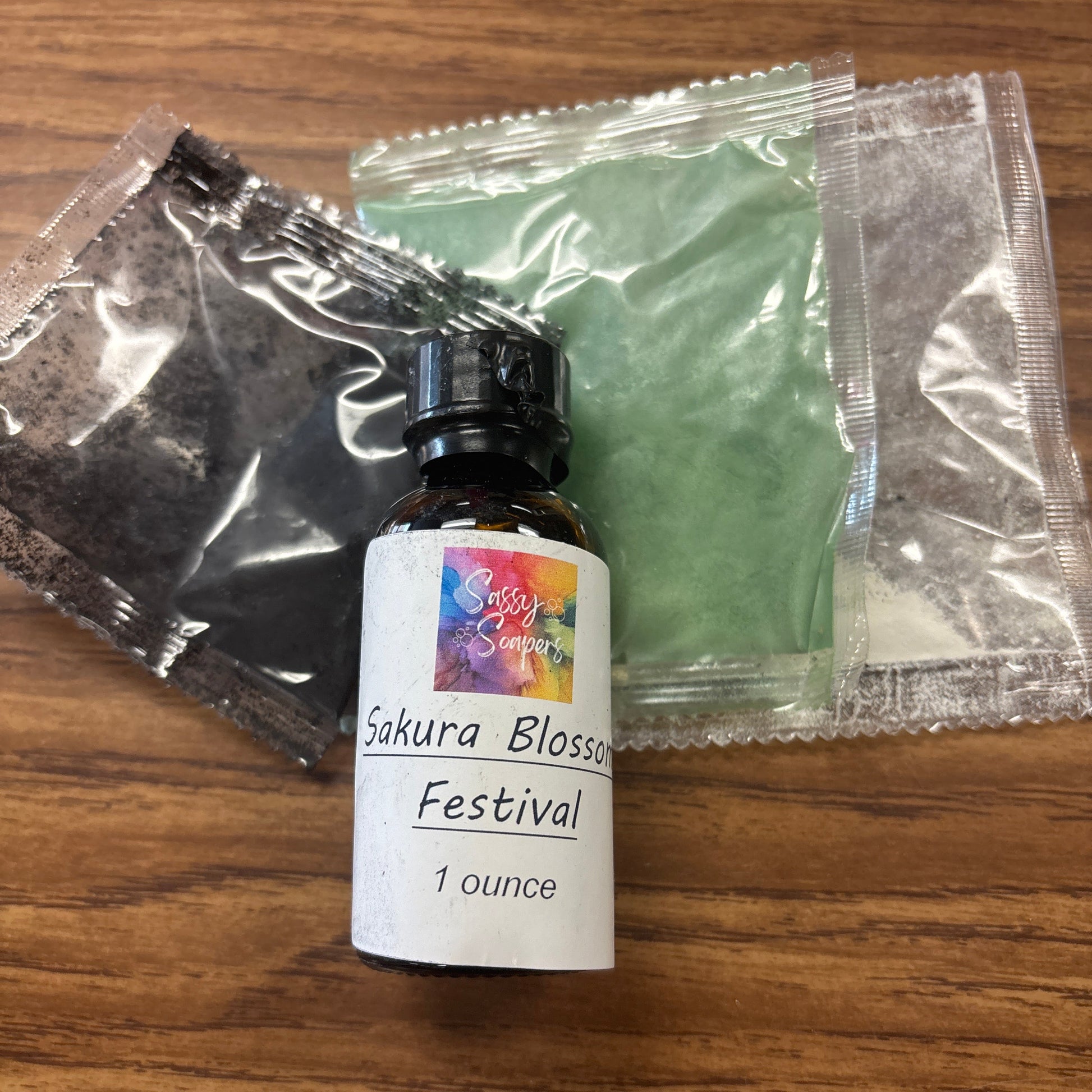 Bottle of Sakura Blossom Festival and kit on a wooden surface