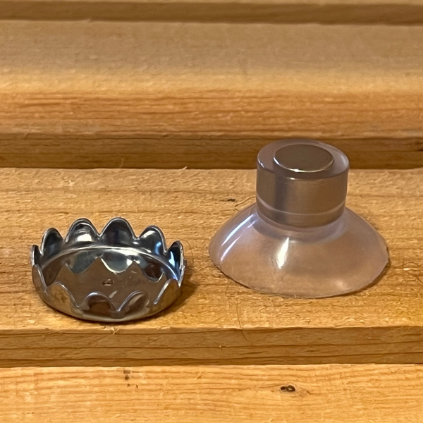 A magnetic soap holder sitting on wood