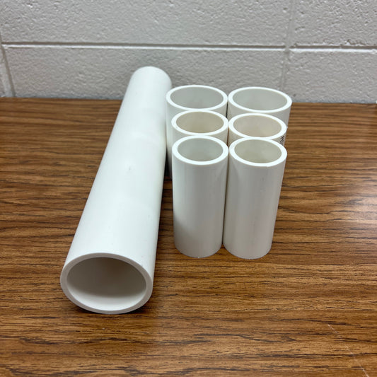 White pipes on a wooden surface with a tiled wall background