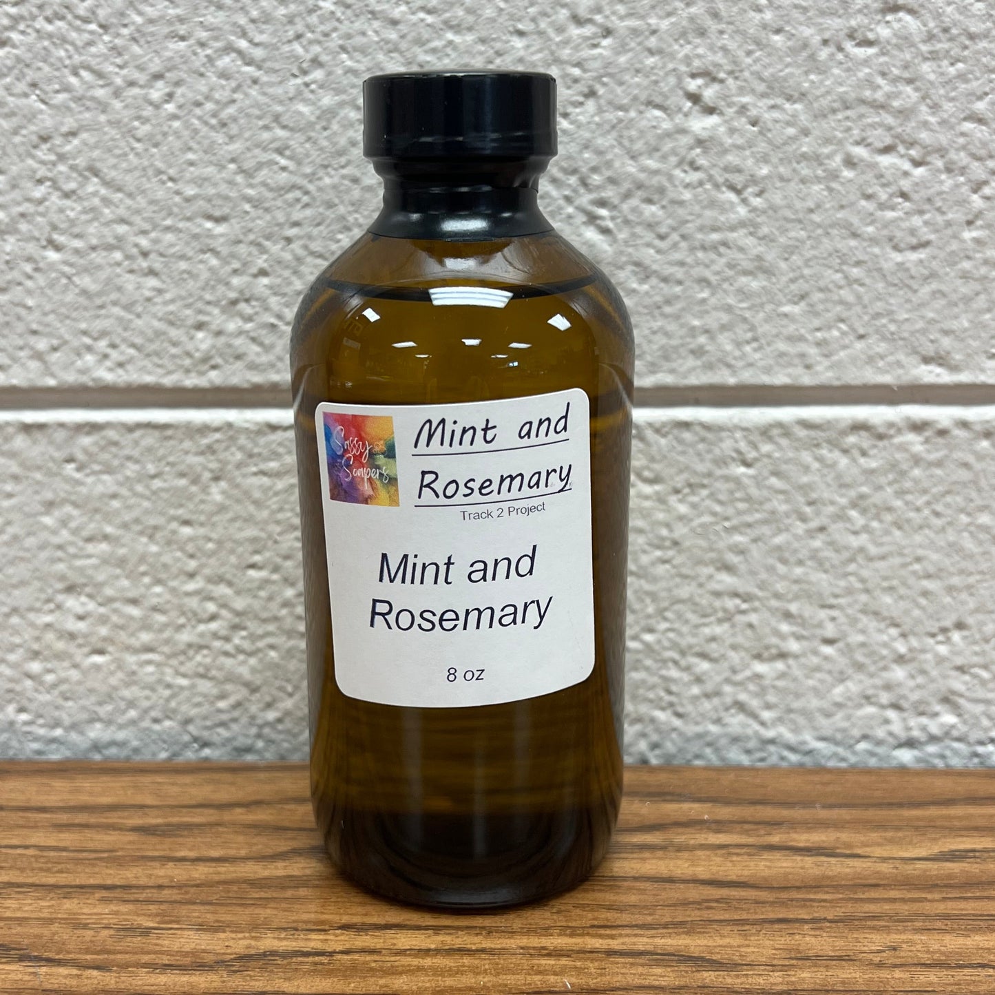 Brown 8 oz bottle of Mint and Rosemary fragrance oil