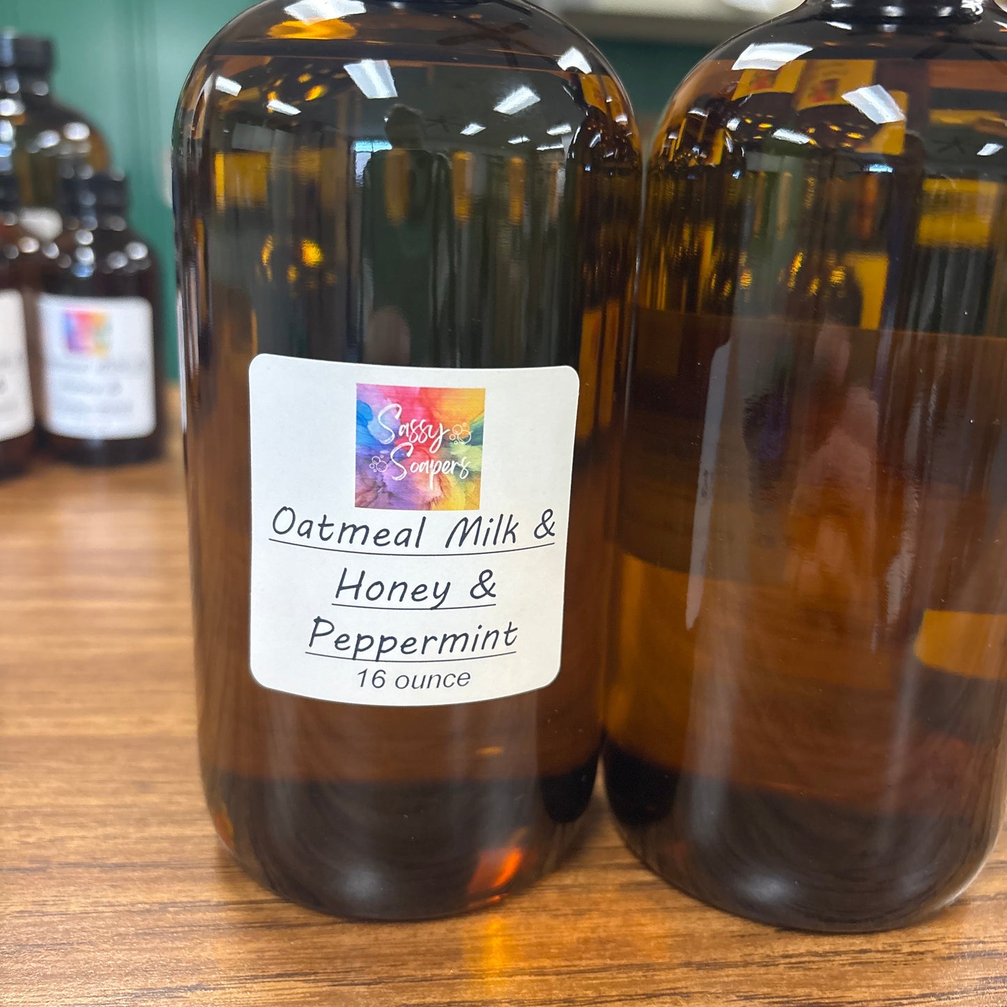 Two bottles of Oatmeal Milk & Honey Peppermint fragrence oils on a wooden surface