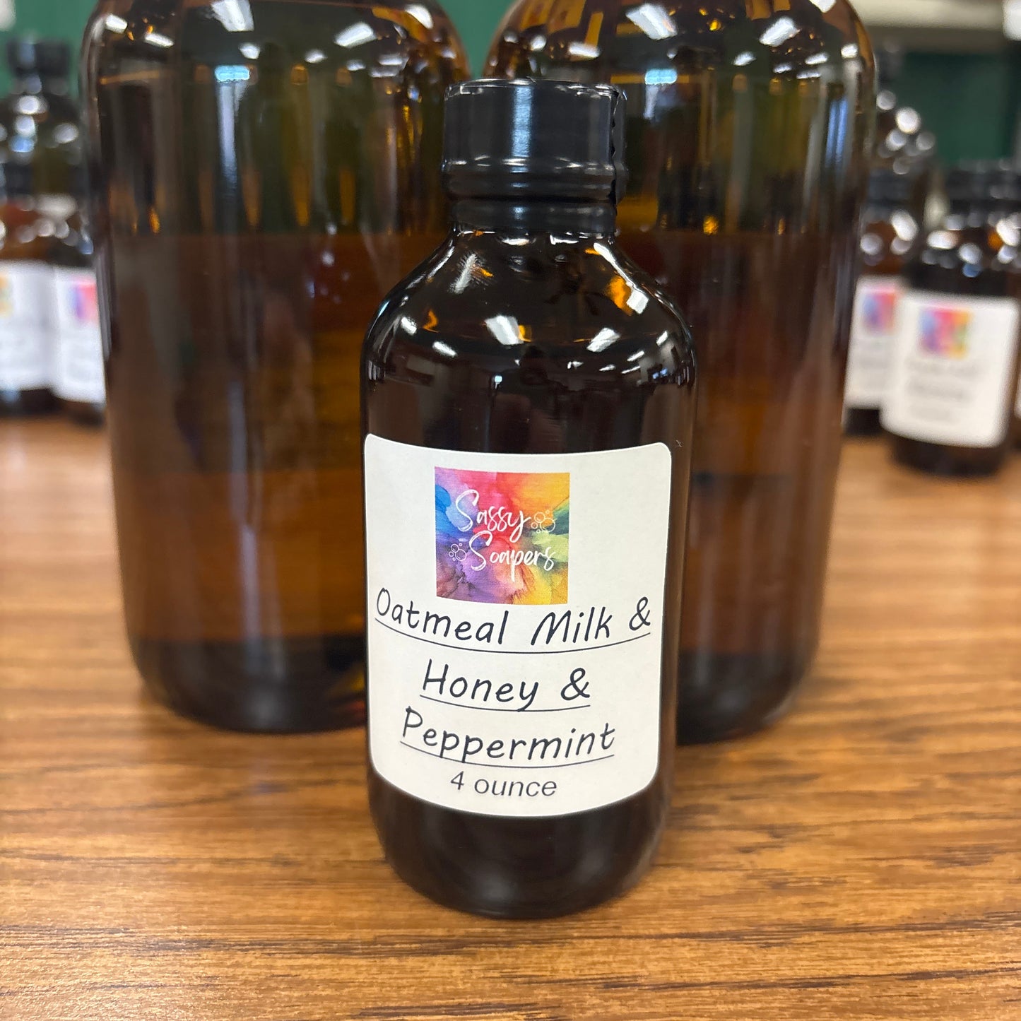Bottle of Oatmeal Milk & Honey fragrence oils with a label on a wooden surface