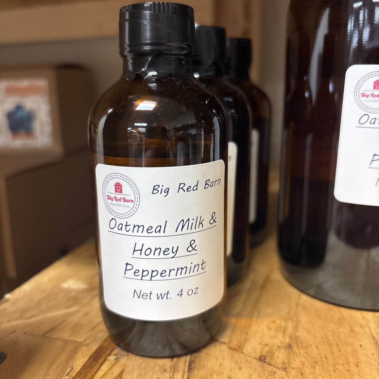 Fragrence oil bottle of Big Red Barn Oatmeal Milk & Honey Peppermint on a wooden surface