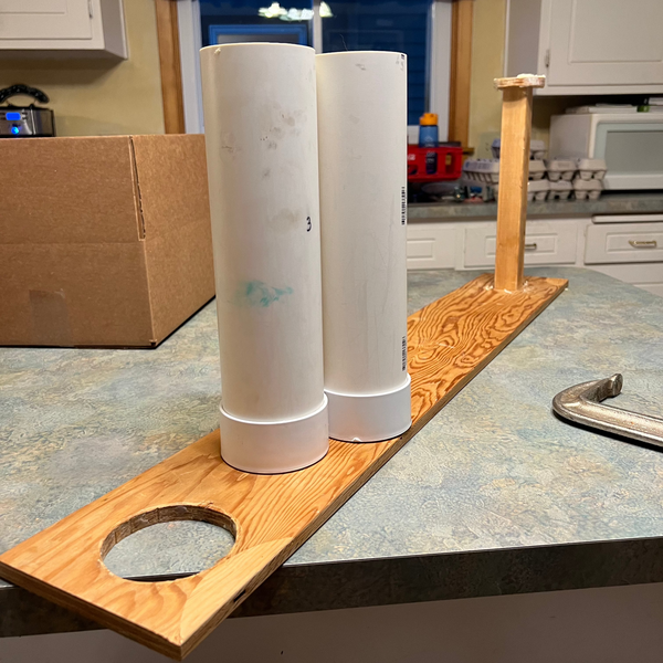 two pvc round soap molds and a wooden tool to remove the soap