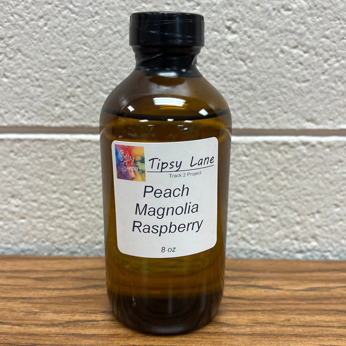 Brown  oz bottle of peach magnolia raspberry fragrance oil.