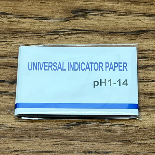PH test strip pack on woodgrain table top