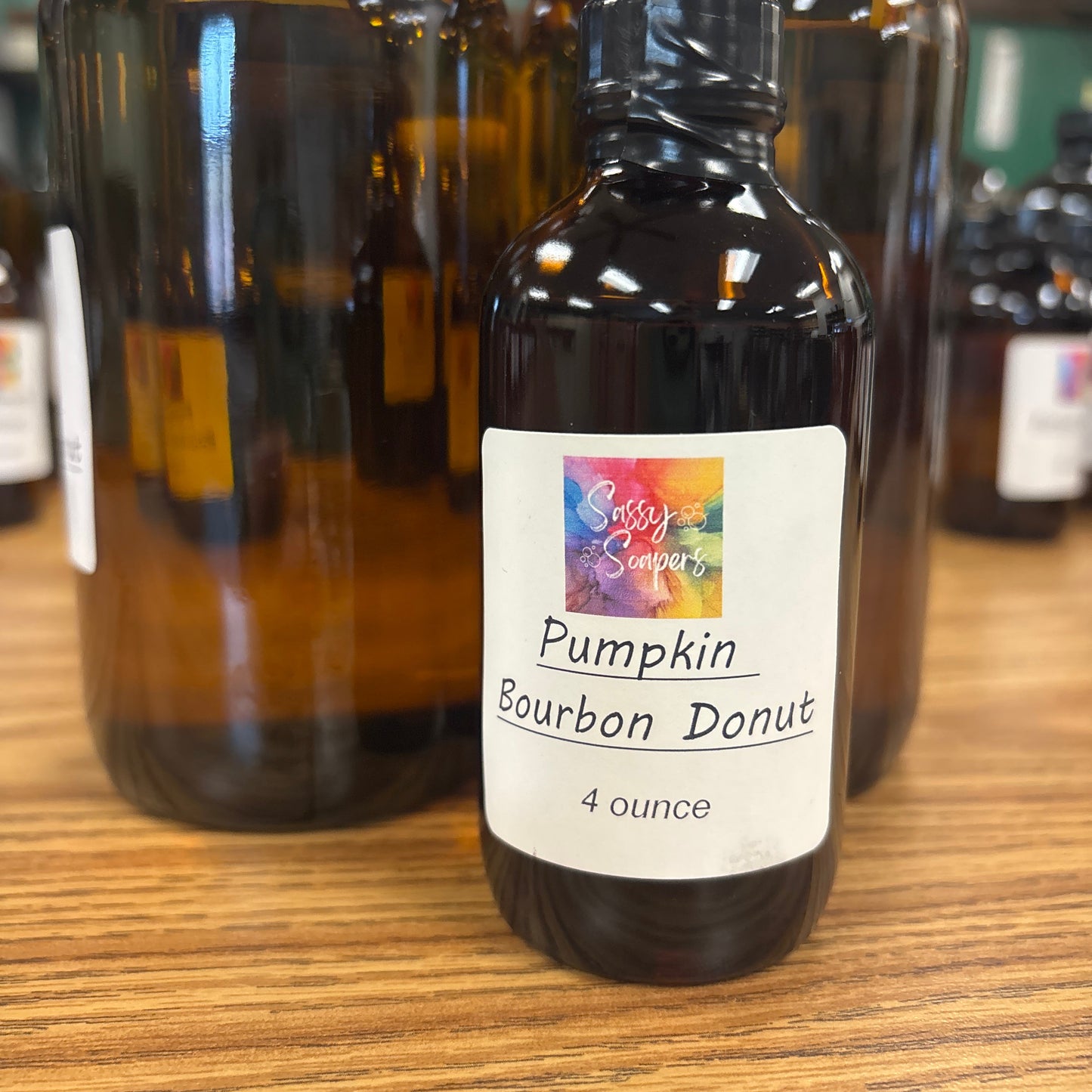 Bottle of Pumpkin Danlet Bourbon fragrence oils on a wooden surface