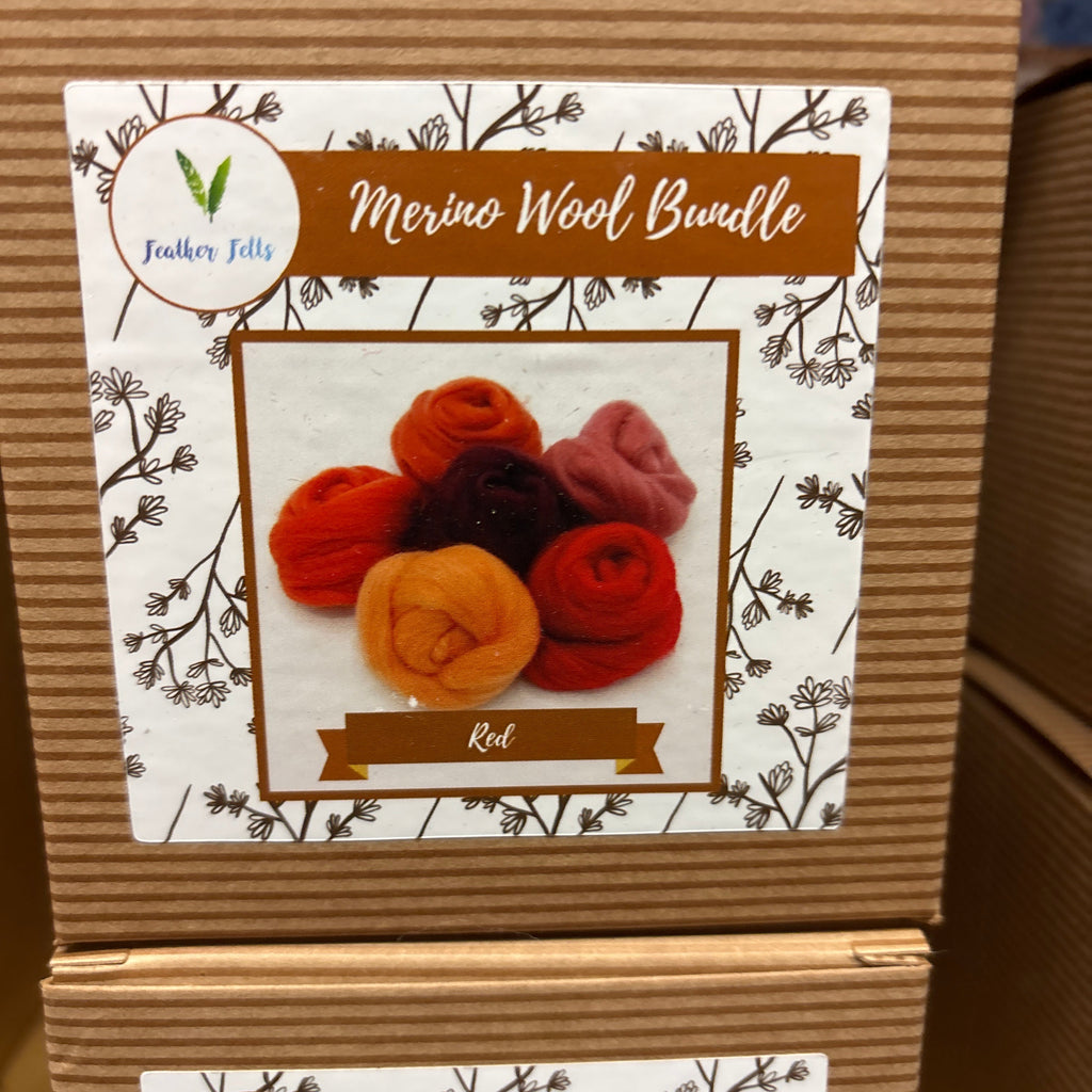 Cardboard box with a label featuring colorful yarn balls and text on a white background.