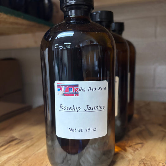 bottle of fragrance oil sitting on a table