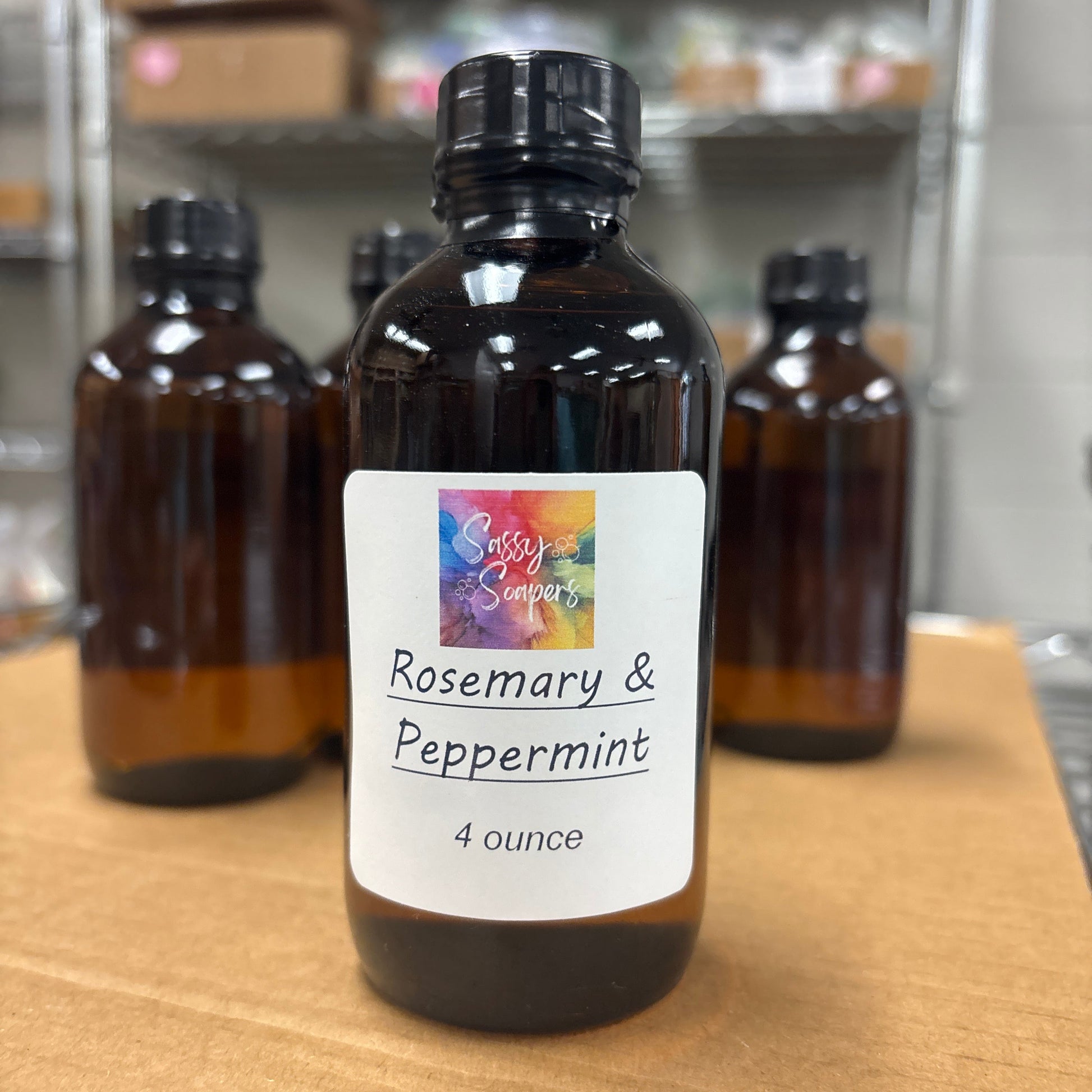 Bottle of Rosemary & Peppermint fragrence oil on a wooden surface