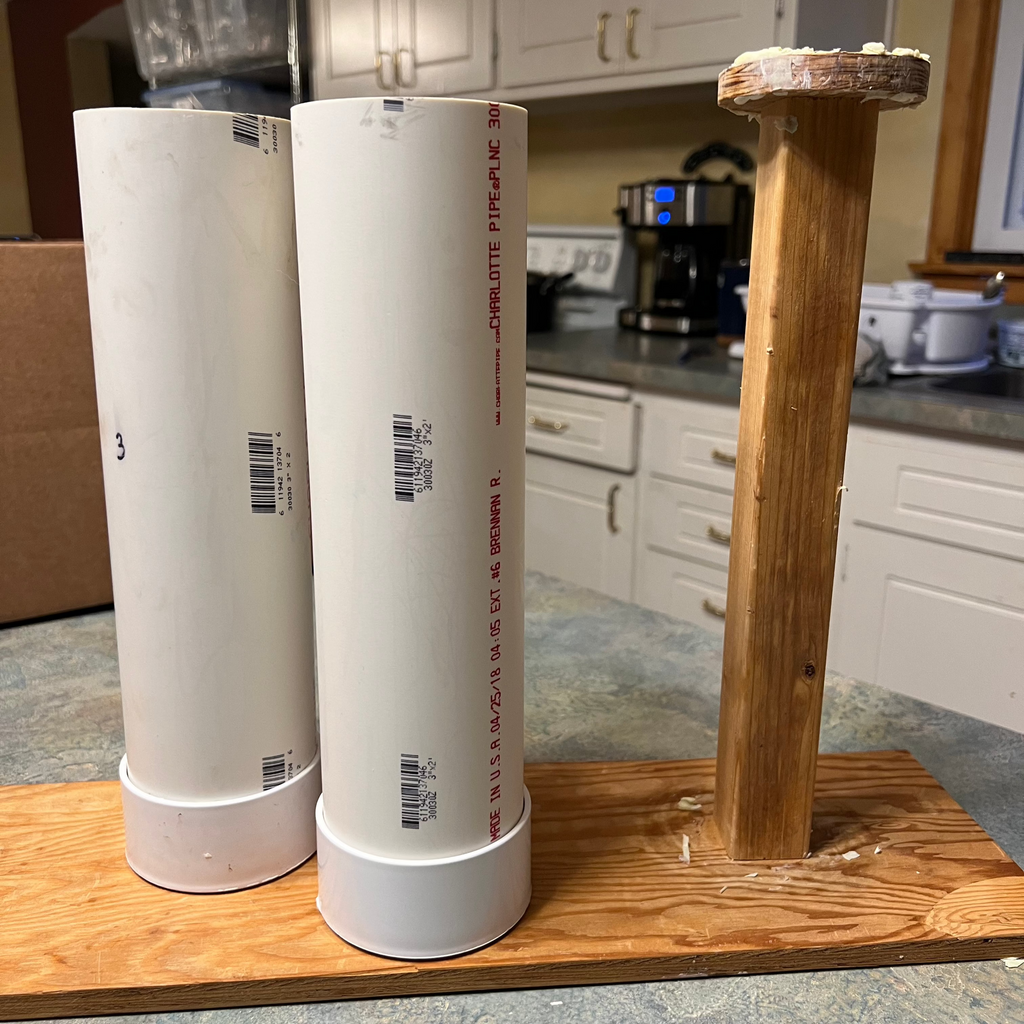 A homemade soap mold set made of PVC and wood, displayed on a kitchen counter.