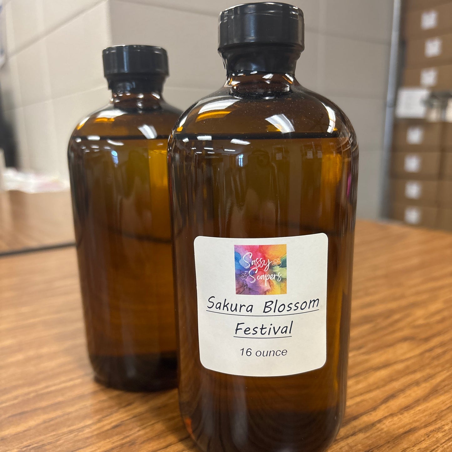 Bottle of Sakura Blossom Festival fragrence on a wooden surface