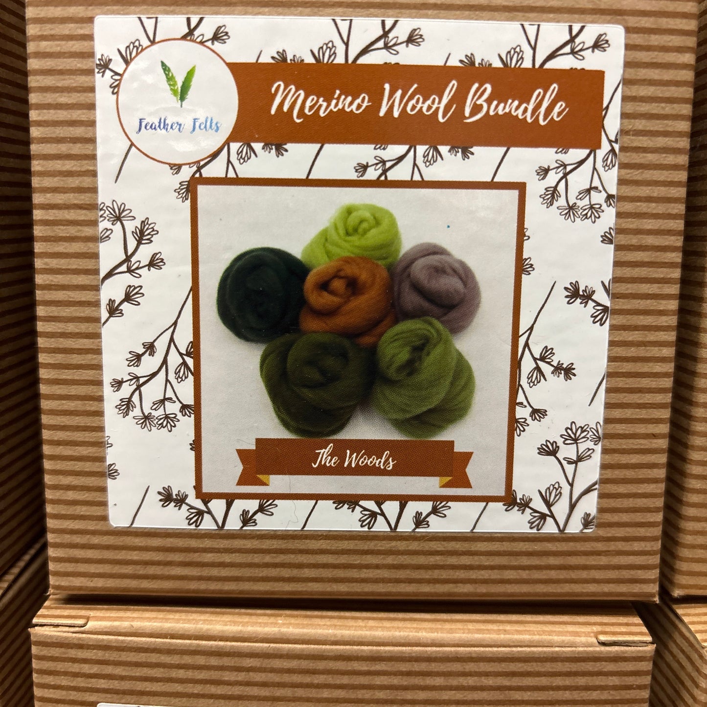 Box of Merino Wool Bundle with colorful wool pieces on a decorative label.