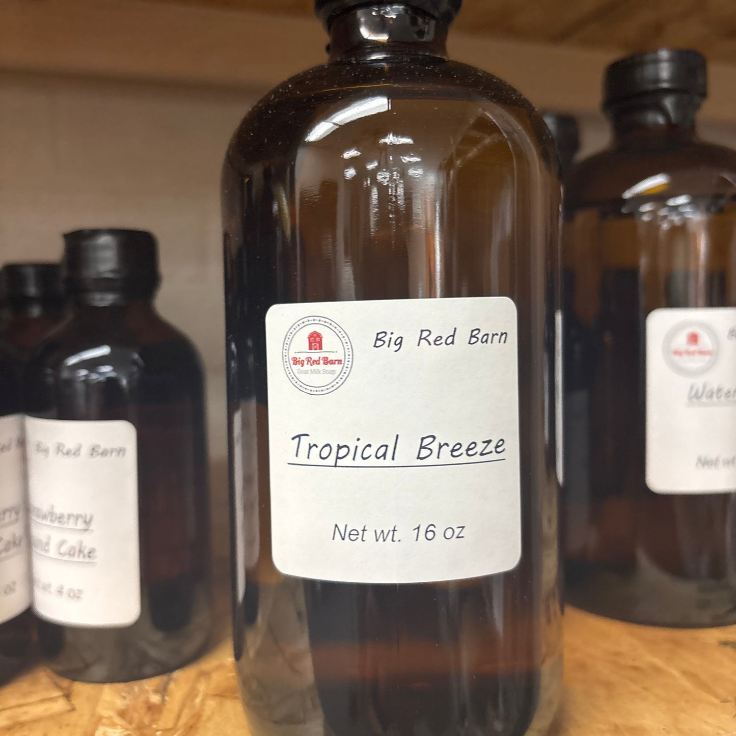 Tropical Breeze fragrance bottle with labels on a wooden surface