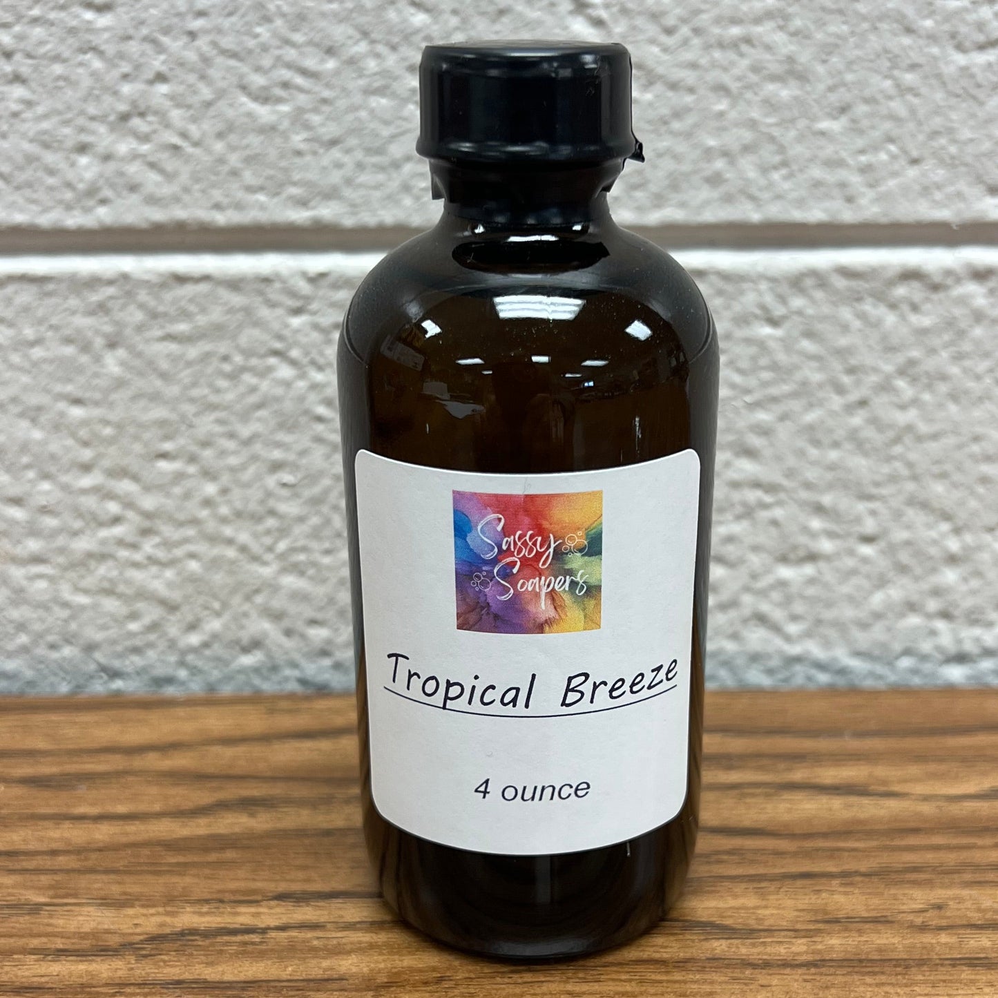 Brown glass 4 oz bottle of Tropical Breeze fragrance oil.