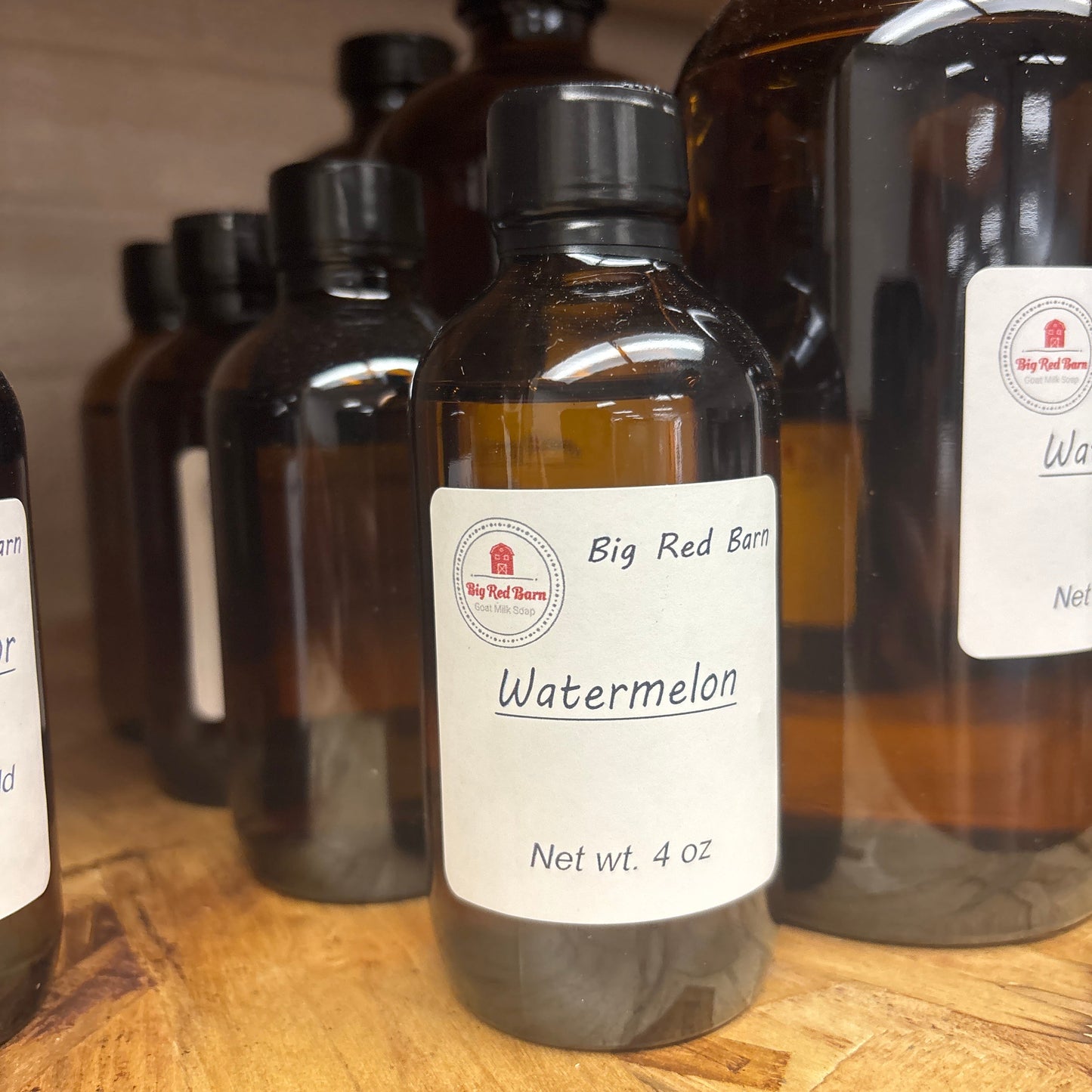 Watermelon fragrance bottle on a wooden surface