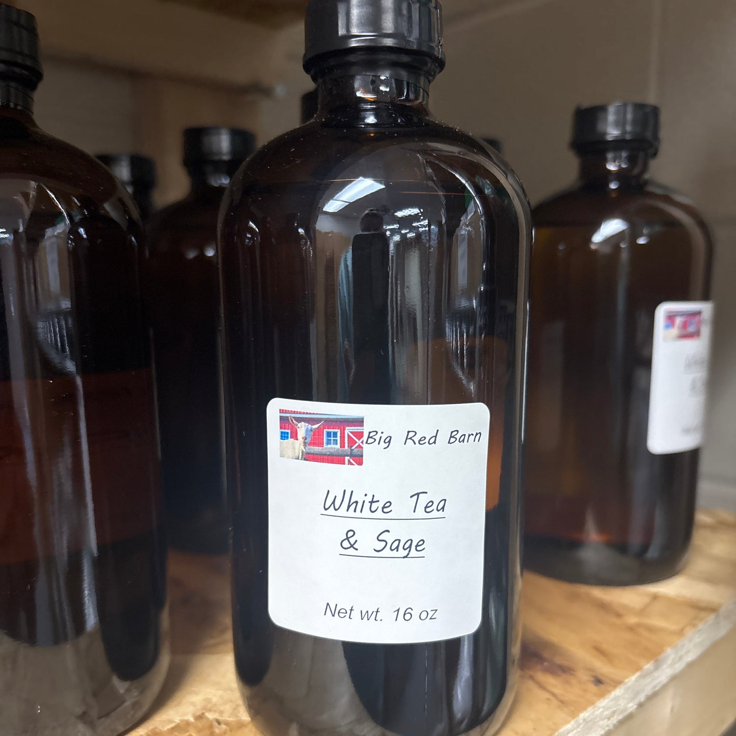 Two dark glass bottles with labels on a wooden surface.